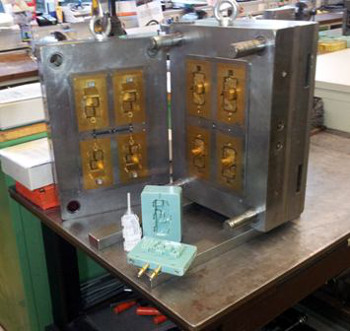 Stratasys additive manufacturing compared to CNC tooling- 3D printed injection mold and resulting part next to steel tool of identical design